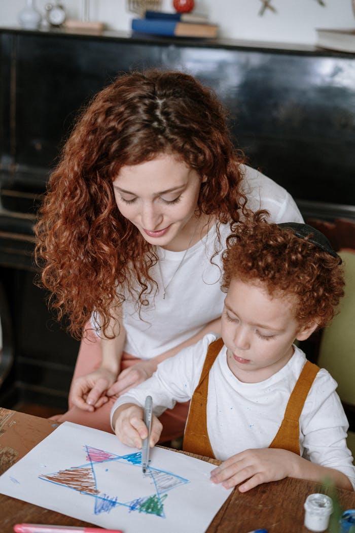 A mother and son enjoying drawing with colorful markers, fostering creativity and family bonding.